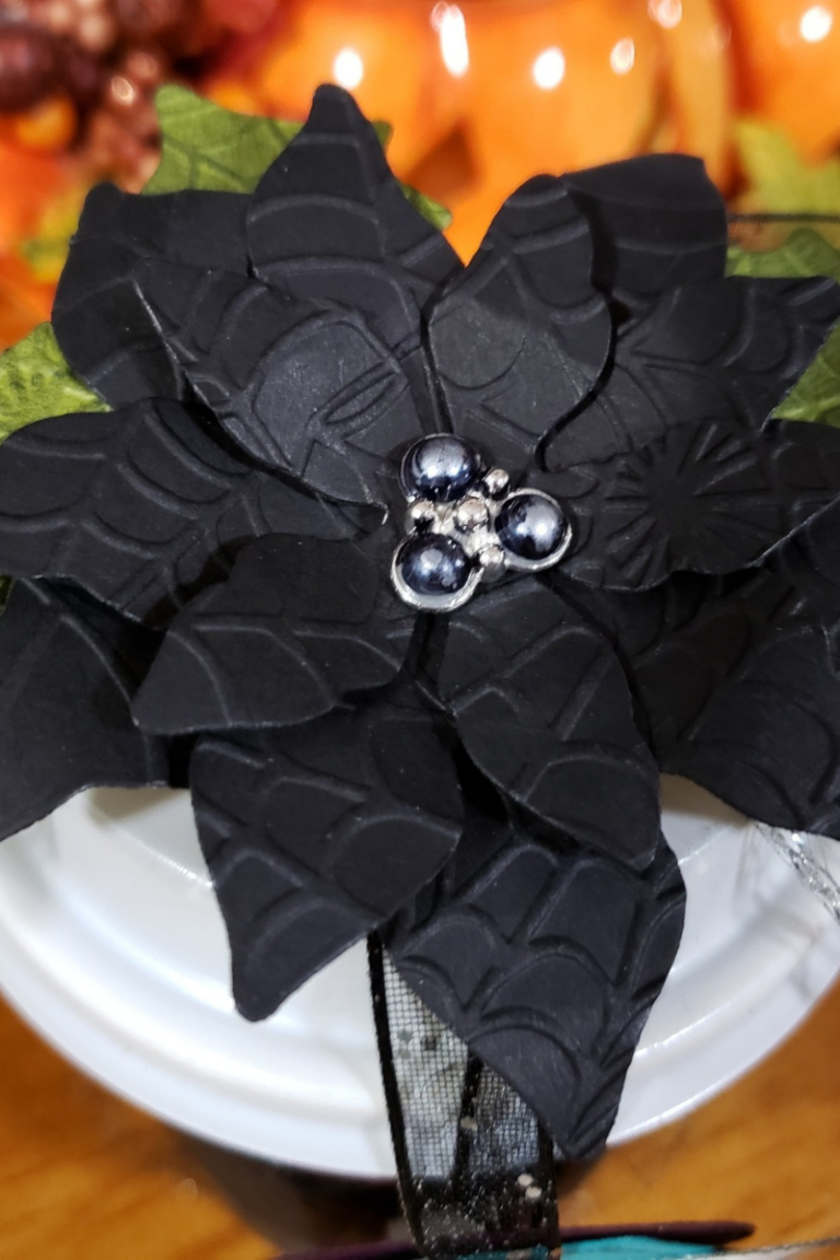 Photo shows the black flower that decorates the top of the Halloween Coffee Cup 3D project