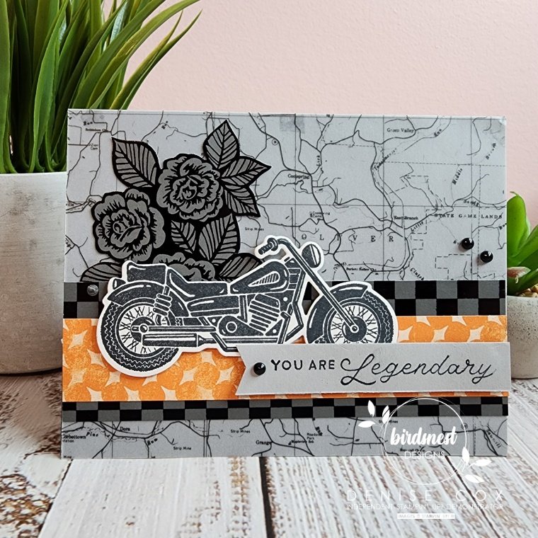 Photo of the front of the Stampin' Up! Legendary Ride card standing on display in front of a plant