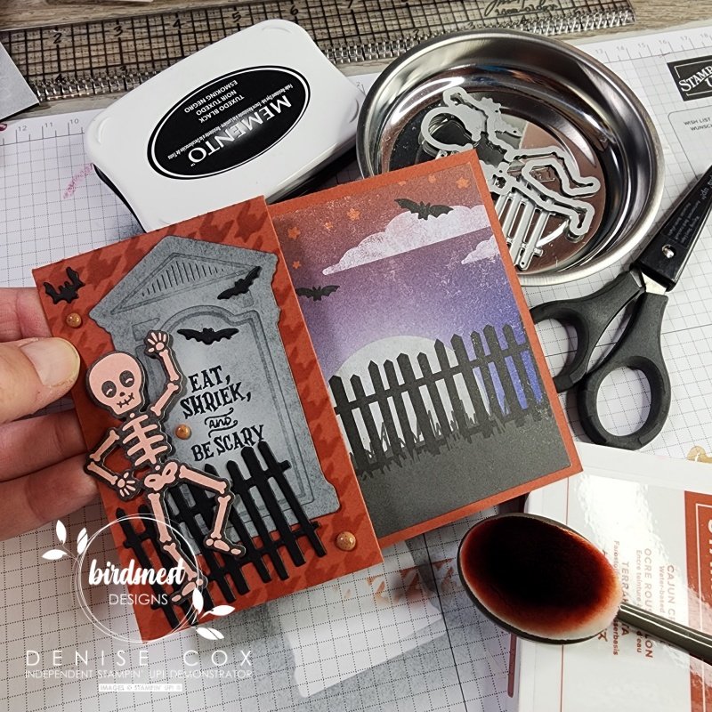 Photo of hand holding the Bag of Bones desk with Stampin Up supplies in the background