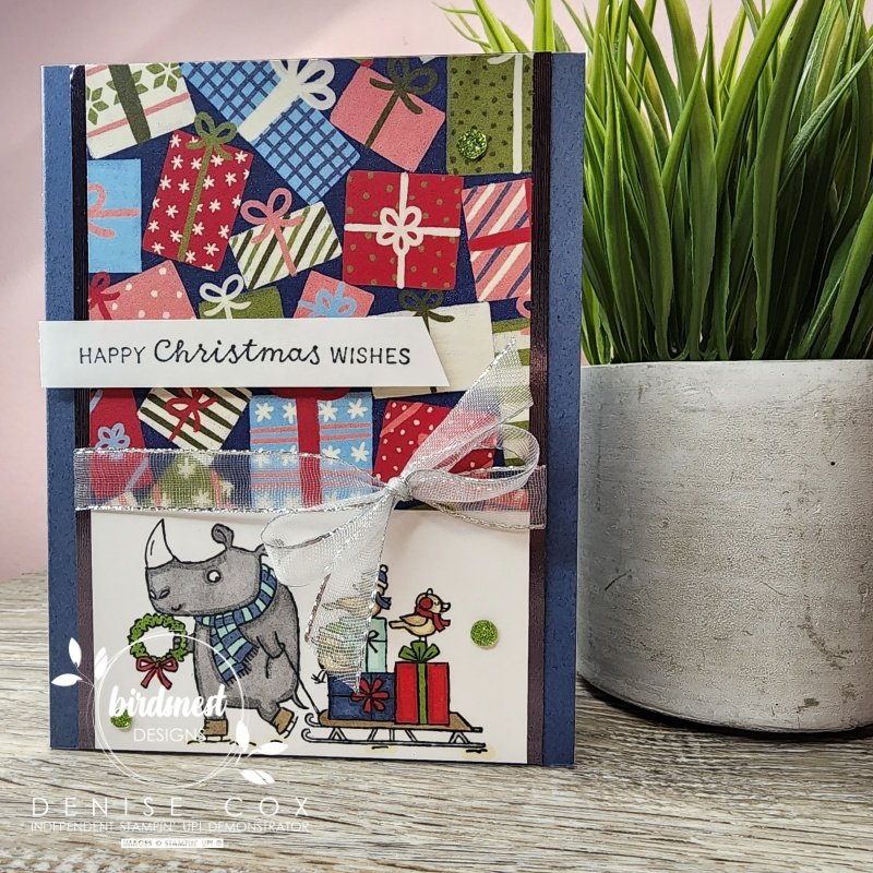 Photo of Stampin' Up! Festive & Fun Christmas card displayed next to a plant
