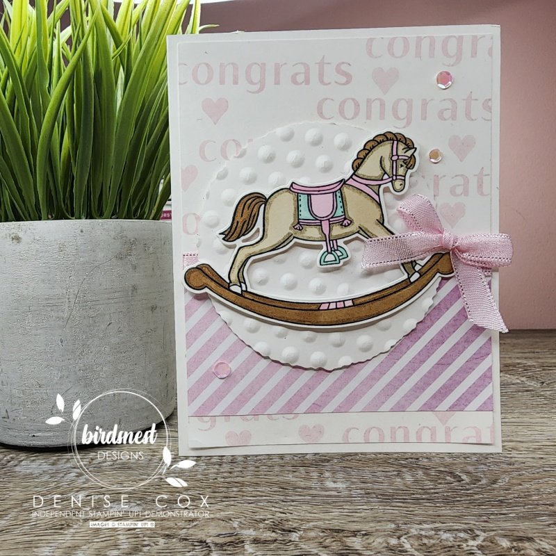 Photo of the Stampin' Up! Rocking Horse baby card displayed on a table by a plant
