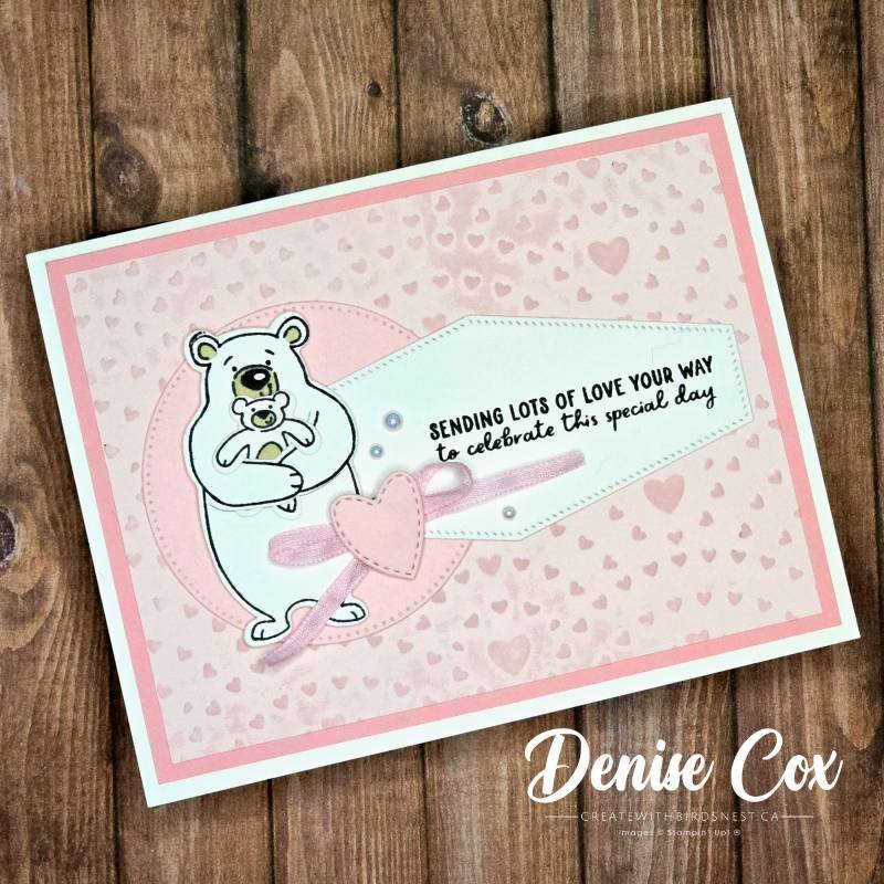 Handmade pink birthday card featuring a bear holding a baby bear, with inked embossed cardstock, soft heart background, and ribbon accent.