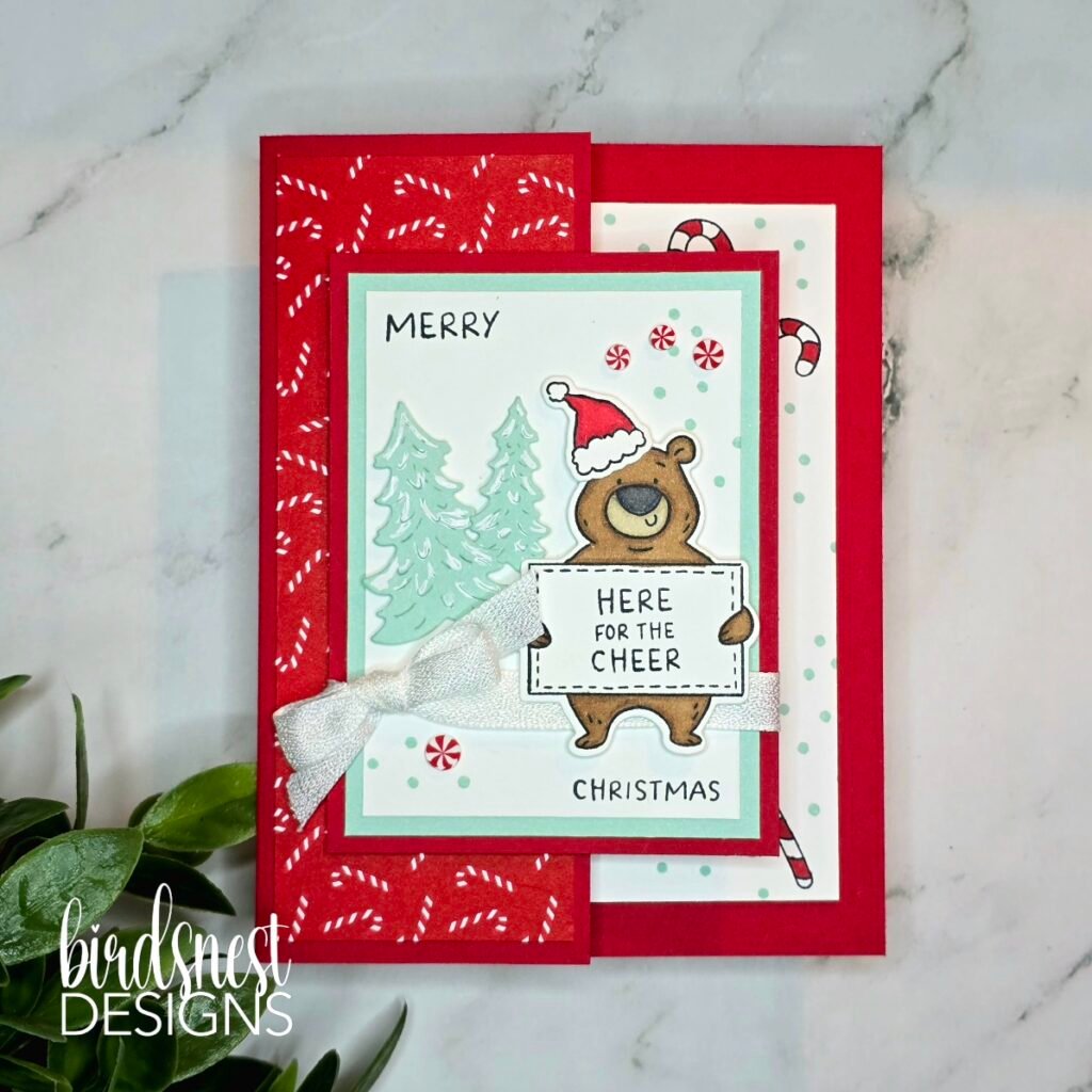Red Christmas fun fold card with a stamped bear, candy canes and peppermint embellishments.